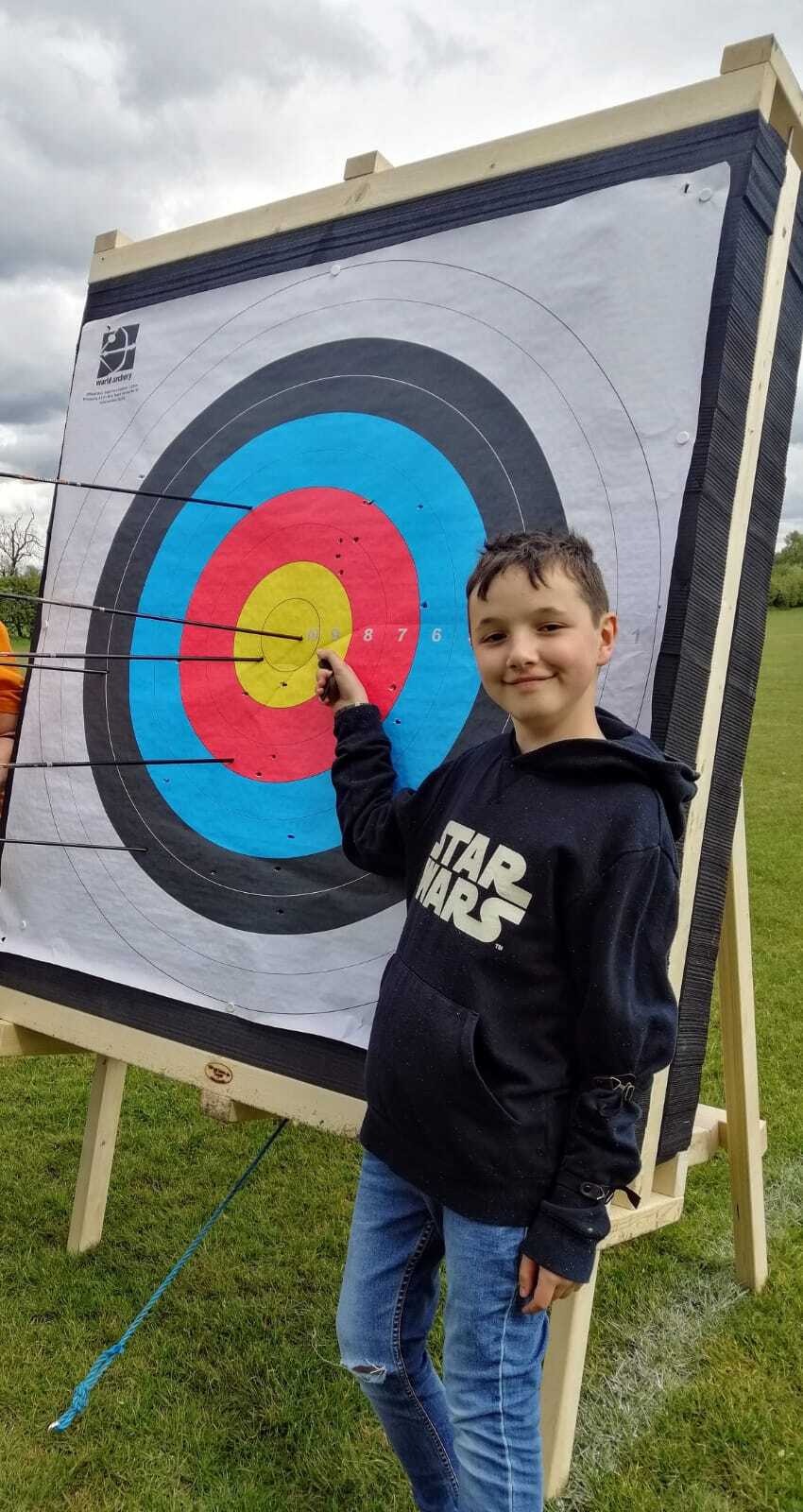 Young boy at archery target